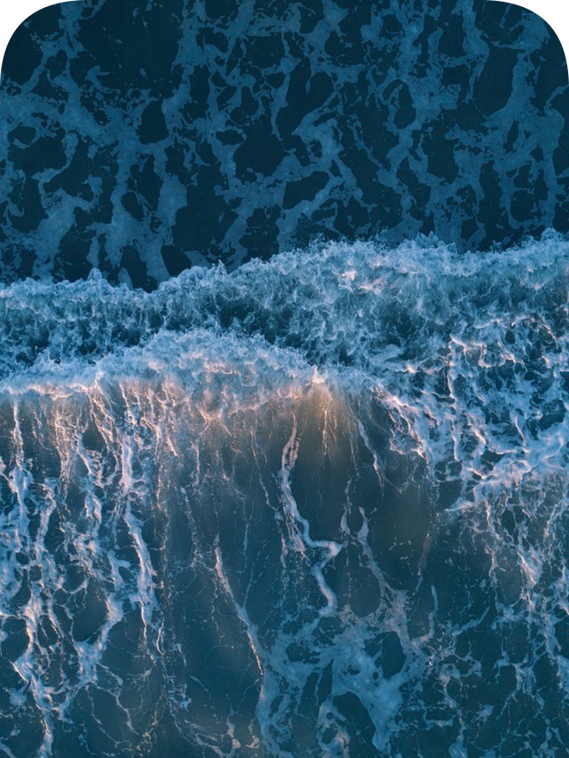 This example rounds only the two top corners of a JPG photo of ocean waves. It sets the rounding radius to 100 pixels and fills the new background with white color. (Source: Pexels.)
