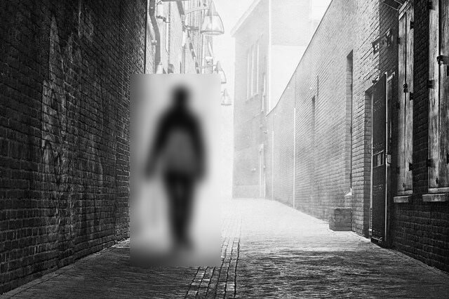 This example blurs the contents of a JPG image within a specific rectangular area. The selected area is positioned to encompass a person walking in an alley. The blurring algorithm softens the details in the rectangle, transforming the sharp features of the person into a blurred silhouette, thus hiding the characteristics that could reveal the person's identity. (Source: Pexels.)